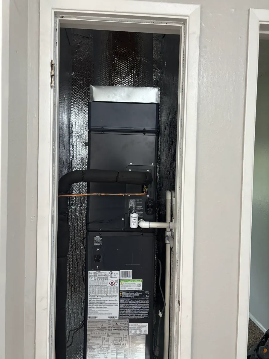An air handler installed in a closet with new copper and drain lines