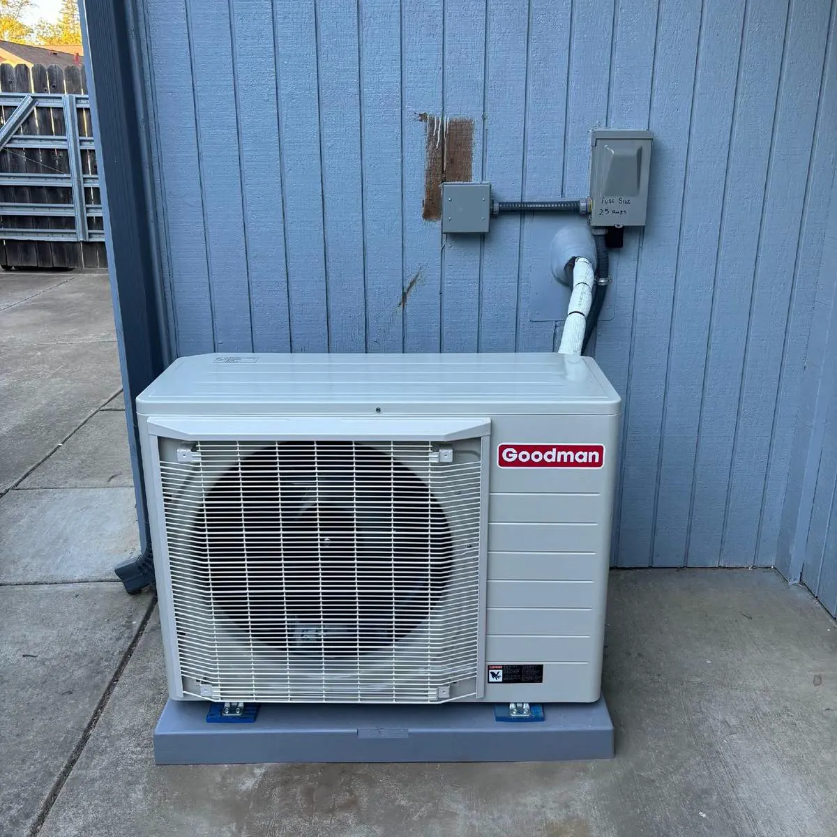 A Goodman ductless mini-split outdoor unit installed on a pad