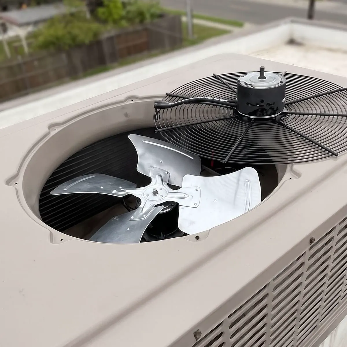 A rooftop package unit with the fan cowl lifted for service